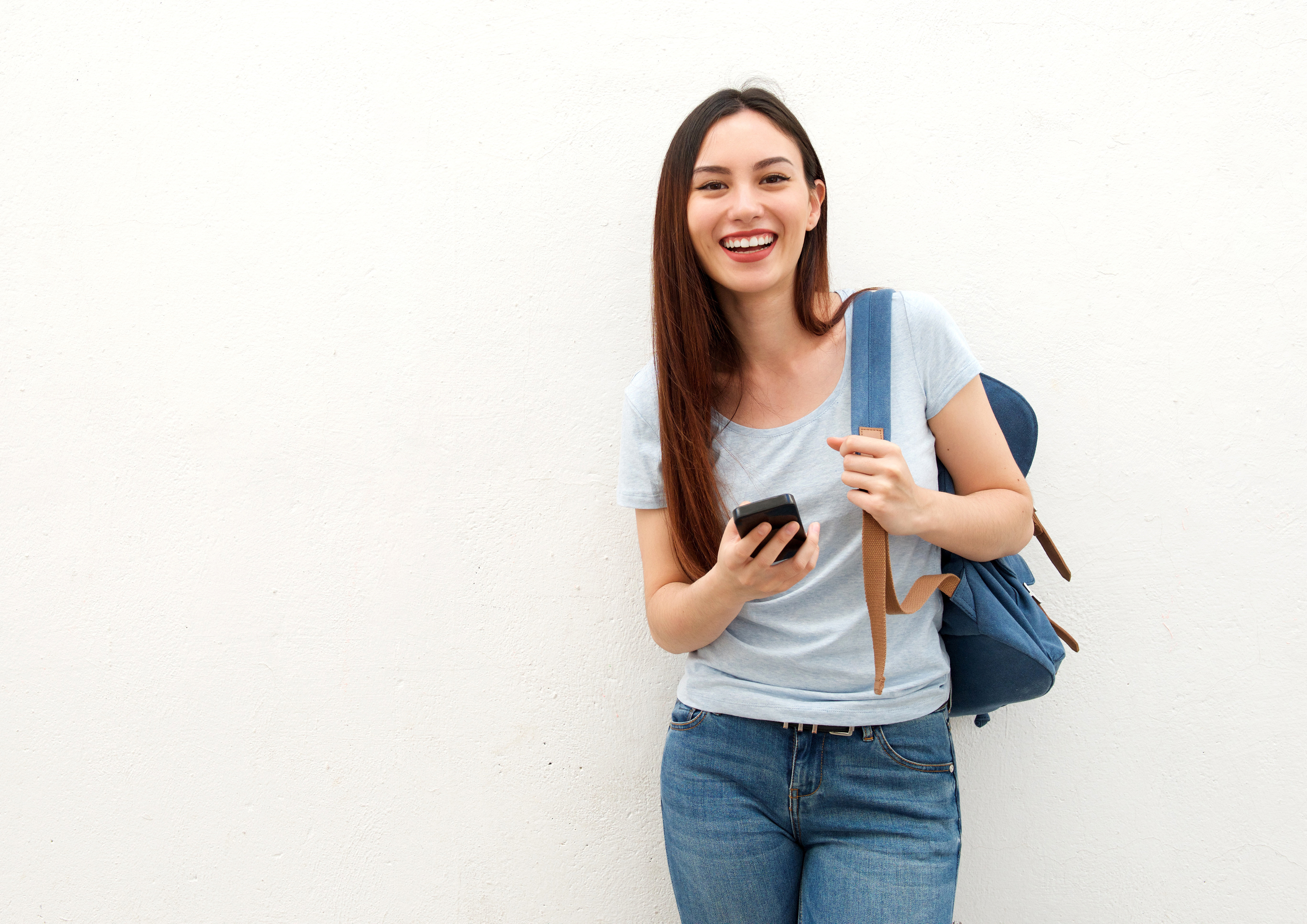 Image of a smiling female student looking at her phone