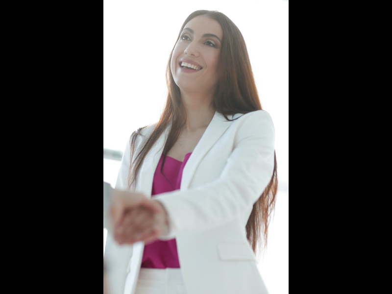 Image of a woman in professional attire shaking hands