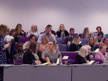 Image on a people engaging in discussions at a conference